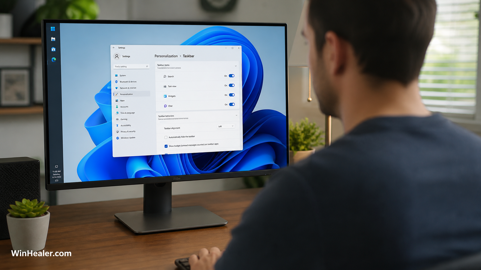 Person adjusting Windows 11 taskbar settings